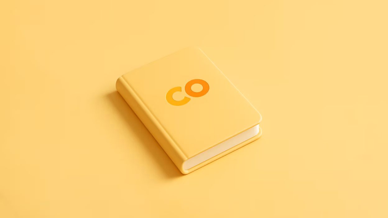 Yellow 3D book featuring the 'CO' logo in orange and yellow tones on its cover.