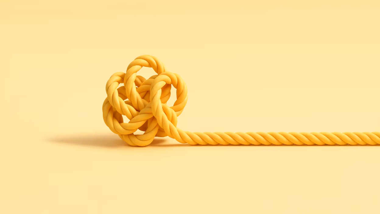 Yellow rope tied in an intricate knot on a yellow background, symbolizing complexity or a tangled problem.